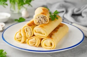Млинці з куркою та грибами: ситний рецепт з ніжною начинкою