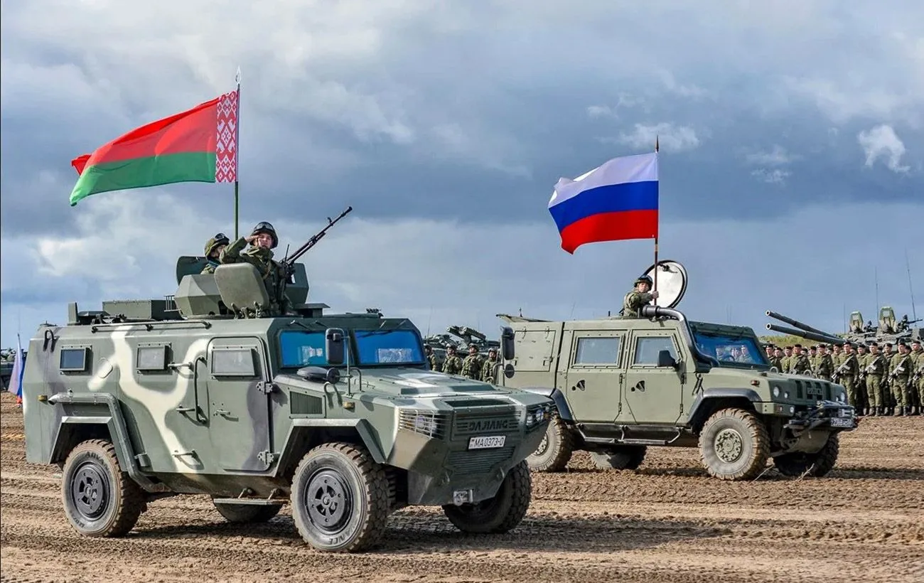 Білоруські та російські бронеавтомобілі з прапорами на полігоні серед солдатів